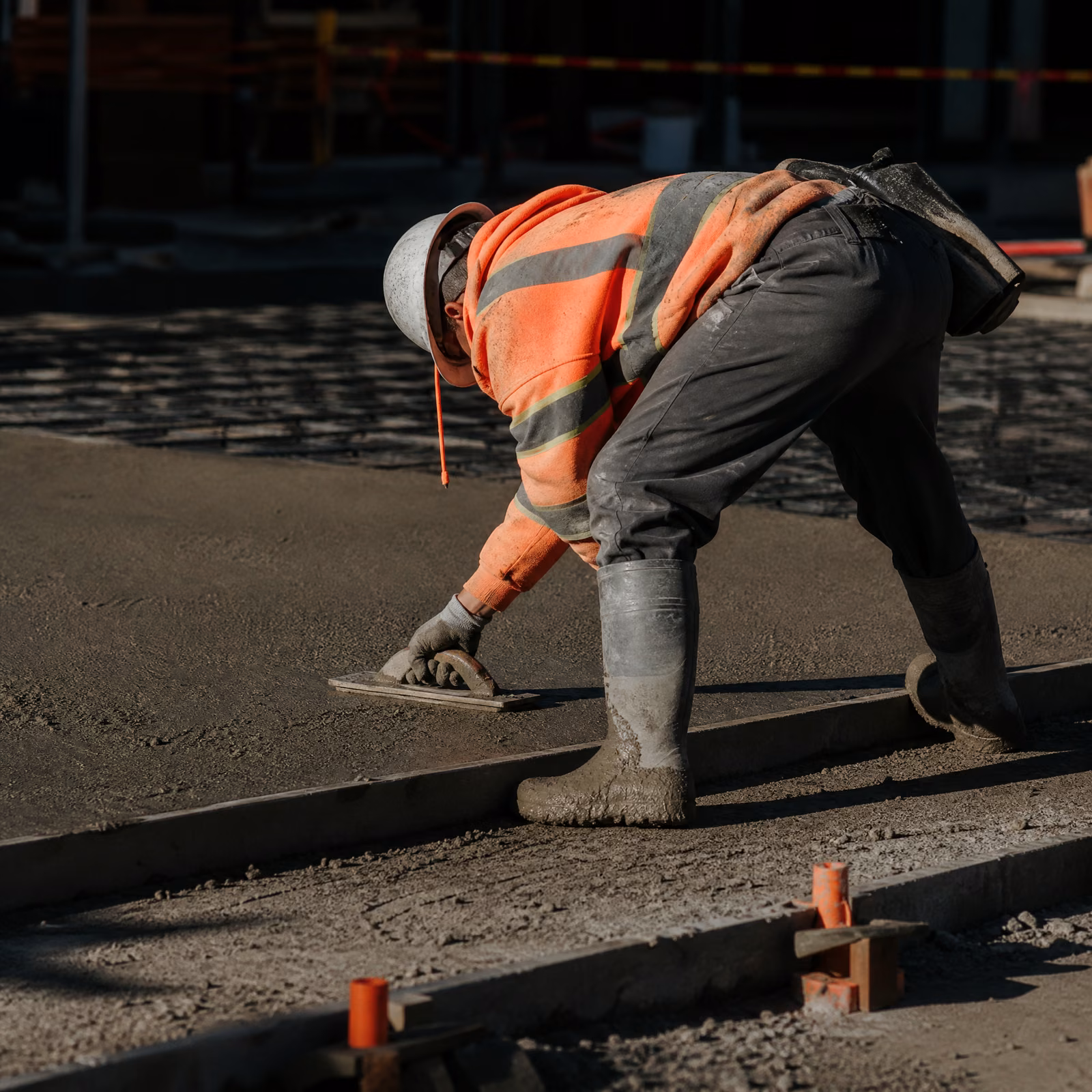 Concrete finisher smoothing a fresh slab
